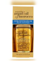 بطری روغن آرگان OGX مدل Extra Penetrating مخصوص موهای خشک و زبر، با درب طلایی و روغن طلایی‌رنگ برای ترمیم و نرمی مو در بسته‌بندی شفاف ۱۰۰ میلی‌لیتری